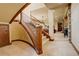 Carpeted staircase with wood banister, leads to lower level and Gathering room at 28800 Stonecrop Trl, Conifer, CO 80433