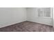 Spacious bedroom featuring a window with blinds, plush carpeting, and outlets for convenience at 910 S Walden St # 106, Aurora, CO 80017
