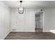 Open dining area with modern light fixture, neutral walls, and doorway to laundry area, perfect for Gathering meals at 910 S Walden St # 106, Aurora, CO 80017