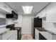 Bright kitchen with white cabinetry and stainless steel appliances at 910 S Walden St # 106, Aurora, CO 80017