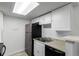 Functional kitchen with stainless steel refrigerator, double basin sink, and neutral countertops for easy food prep at 910 S Walden St # 106, Aurora, CO 80017