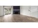 Spacious living room with stone fireplace, wood flooring, and sliding doors at 910 S Walden St # 106, Aurora, CO 80017