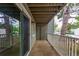 This is an outdoor patio with sliding glass doors, a white railing and a view of the surrounding area at 910 S Walden St # 106, Aurora, CO 80017