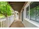 A relaxing outdoor patio with a white railing and a view of the surrounding area at 910 S Walden St # 106, Aurora, CO 80017