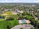 Extensive aerial perspective highlighting a park with a school, fields, and recreational facilities at 11578 Clayton St, Thornton, CO 80233