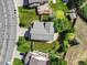 Aerial view of the home displaying its landscaped backyard, patio, and driveway at 11578 Clayton St, Thornton, CO 80233