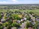 Areal view of the home in a neighborhood with mature trees, green spaces, and community streets at 11578 Clayton St, Thornton, CO 80233
