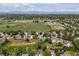 Wide aerial shot showcasing homes in a neighborhood with green spaces and a mountain view at 11578 Clayton St, Thornton, CO 80233