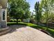 A stamped concrete patio with a spacious backyard, mature trees, and a storage shed at 11578 Clayton St, Thornton, CO 80233