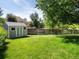 Backyard view showcasing a well-maintained lawn and a charming storage shed at 11578 Clayton St, Thornton, CO 80233