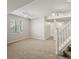 Partially finished basement with carpet, stairs, and ample lighting at 11578 Clayton St, Thornton, CO 80233