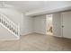 Unfinished basement space featuring neutral carpet, staircase and access to a bathroom and a storage area at 11578 Clayton St, Thornton, CO 80233