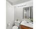 Bathroom vanity with framed mirror, updated lighting, toilet, and decorative accents at 11578 Clayton St, Thornton, CO 80233