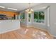 Bright dining area adjacent to kitchen featuring wood floors and many windows allowing ample light at 11578 Clayton St, Thornton, CO 80233