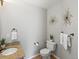 This half bath features unique decor and a granite topped vanity at 11578 Clayton St, Thornton, CO 80233