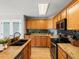 Modern kitchen featuring granite countertops, stainless steel appliances, and ample cabinet space at 11578 Clayton St, Thornton, CO 80233