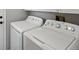 Convenient laundry room with white washer and dryer units and ample storage space at 11578 Clayton St, Thornton, CO 80233