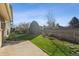 Well-maintained backyard featuring a green lawn, concrete patio, and established landscaping at 7410 S Dahlia Ct, Centennial, CO 80122