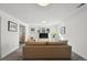 Cozy basement space featuring plush carpeting, a comfortable sofa, and natural light from the window at 7410 S Dahlia Ct, Centennial, CO 80122