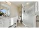 Well-lit bathroom boasting a clear glass shower and a white vanity at 7410 S Dahlia Ct, Centennial, CO 80122