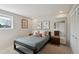 Cozy bedroom featuring neutral wall colors, a queen bed, and ample natural light at 7410 S Dahlia Ct, Centennial, CO 80122