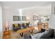 Open-concept living and dining area with hardwood floors, modern furnishings, and plenty of natural light at 7410 S Dahlia Ct, Centennial, CO 80122