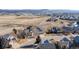 Expansive aerial shot showcasing a neighborhood with houses near a large open field at 4695 Bobolink Dr, Castle Rock, CO 80109