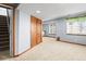 Finished basement area with neutral carpet, closet storage, and windows at 4695 Bobolink Dr, Castle Rock, CO 80109