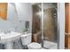 Bathroom with tiled shower with bench, modern fixtures, sink and commode at 4695 Bobolink Dr, Castle Rock, CO 80109