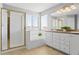 Bathroom with white cabinets, double sinks, a shower, and a soaking tub at 4695 Bobolink Dr, Castle Rock, CO 80109