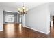 Open dining area with hardwood floors, a chandelier, and neutral wall paint at 4695 Bobolink Dr, Castle Rock, CO 80109