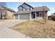 Two-story home with a three-car garage, stone accents, and well-maintained lawn at 4695 Bobolink Dr, Castle Rock, CO 80109