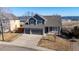 Charming two-story home featuring a three car garage, stone accents, and a welcoming front porch at 4695 Bobolink Dr, Castle Rock, CO 80109