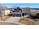 Charming gray two-story home featuring a three-car garage and a welcoming front porch at 4695 Bobolink Dr, Castle Rock, CO 80109