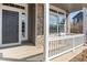 Charming covered front porch with gray trim and stone accents at entry at 4695 Bobolink Dr, Castle Rock, CO 80109