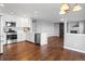 Modern kitchen with stainless steel appliances, white cabinets and hardwood floors at 4695 Bobolink Dr, Castle Rock, CO 80109