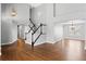 Bright and airy living room featuring hardwood floors, a staircase, and an open layout at 4695 Bobolink Dr, Castle Rock, CO 80109