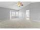 Spacious primary bedroom featuring a ceiling fan and a large window with plenty of natural light at 4695 Bobolink Dr, Castle Rock, CO 80109