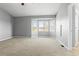 Bedroom with neutral carpet, soft gray walls, and large window showcasing mountain views at 4695 Bobolink Dr, Castle Rock, CO 80109