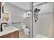 Modern bathroom featuring sleek tiling, dark fixtures, and a glass-enclosed shower at 33477 Valley View Dr, Evergreen, CO 80439