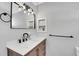 Stylish bathroom vanity with a white countertop, dark fixtures, and modern lighting at 33477 Valley View Dr, Evergreen, CO 80439