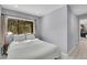 Cozy bedroom featuring a wooded view from the window and neutral decor at 33477 Valley View Dr, Evergreen, CO 80439