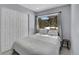 Cozy bedroom with sliding door closet, comfortable bed, and view of the snowy forest at 33477 Valley View Dr, Evergreen, CO 80439