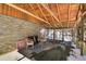 Wonderful deck has log beam ceiling and stone wall, creating a relaxing setting for enjoying the outdoors at 33477 Valley View Dr, Evergreen, CO 80439