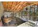 Relaxing deck area with log beam construction with an outdoor table and seating with a beautiful winter view at 33477 Valley View Dr, Evergreen, CO 80439