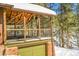 A well built covered deck sits atop an attached garage, with a forest of pines as a natural privacy barrier at 33477 Valley View Dr, Evergreen, CO 80439