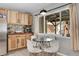 Well-lit kitchen featuring knotty wood cabinetry, stainless steel appliances, and a modern round breakfast table at 33477 Valley View Dr, Evergreen, CO 80439