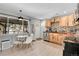 Eat-in kitchen featuring wood cabinets, stainless steel appliances, and a bright dining area at 33477 Valley View Dr, Evergreen, CO 80439