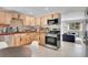 Updated kitchen with stainless steel appliances, custom backsplash, and view to the cozy living room at 33477 Valley View Dr, Evergreen, CO 80439