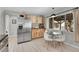 Bright kitchen with stainless steel refrigerator and adjacent eat-in area with large window and natural light at 33477 Valley View Dr, Evergreen, CO 80439